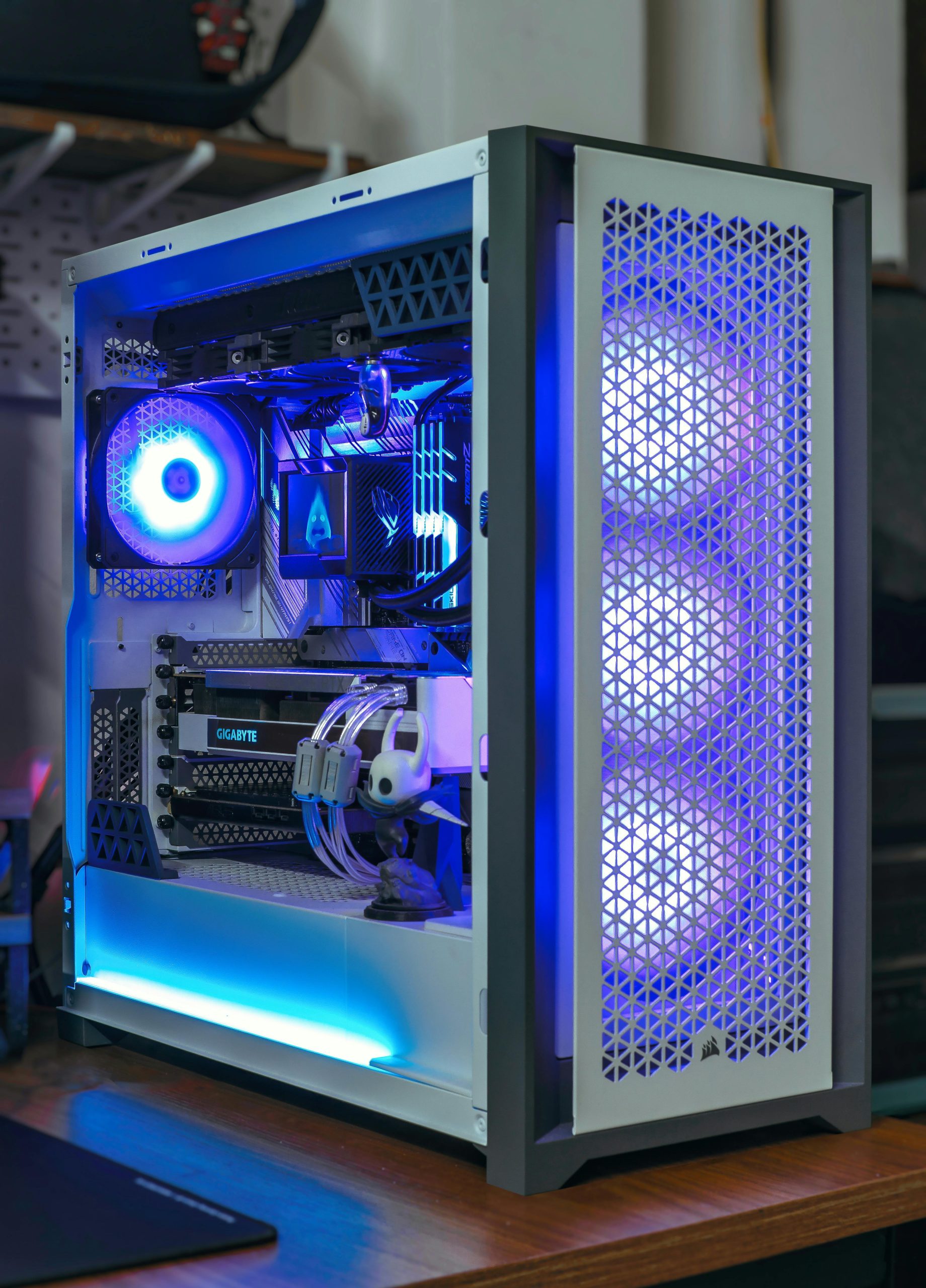 A sleek desktop PC with vibrant blue RGB lighting showcasing modern computer technology.